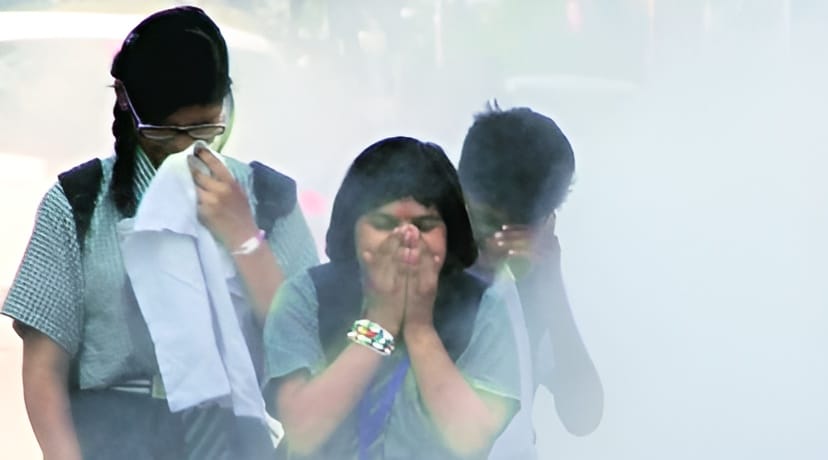 Three students covering their faces to protect from air pollution